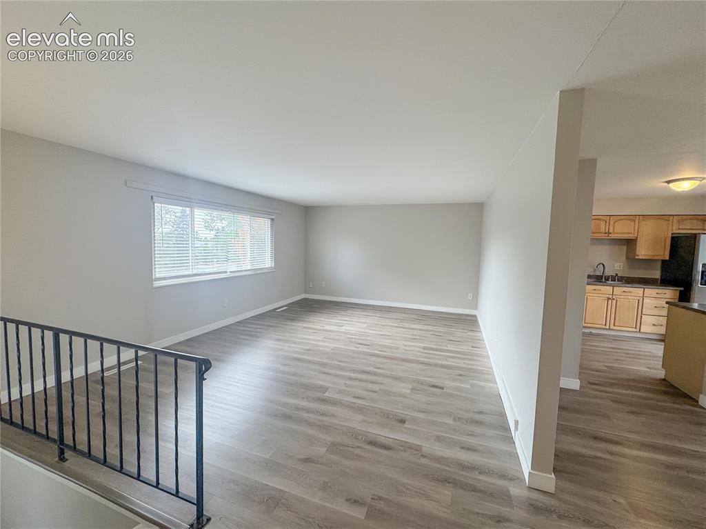 Image 8 of 42: Open-concept interior featuring wood-finish flooring, a large picture windo