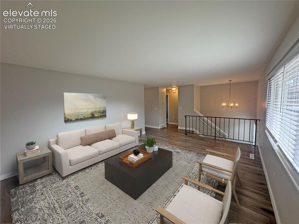 Image 9 of 42: virtually staged Spacious living area featuring wood-finish flooring, a mul