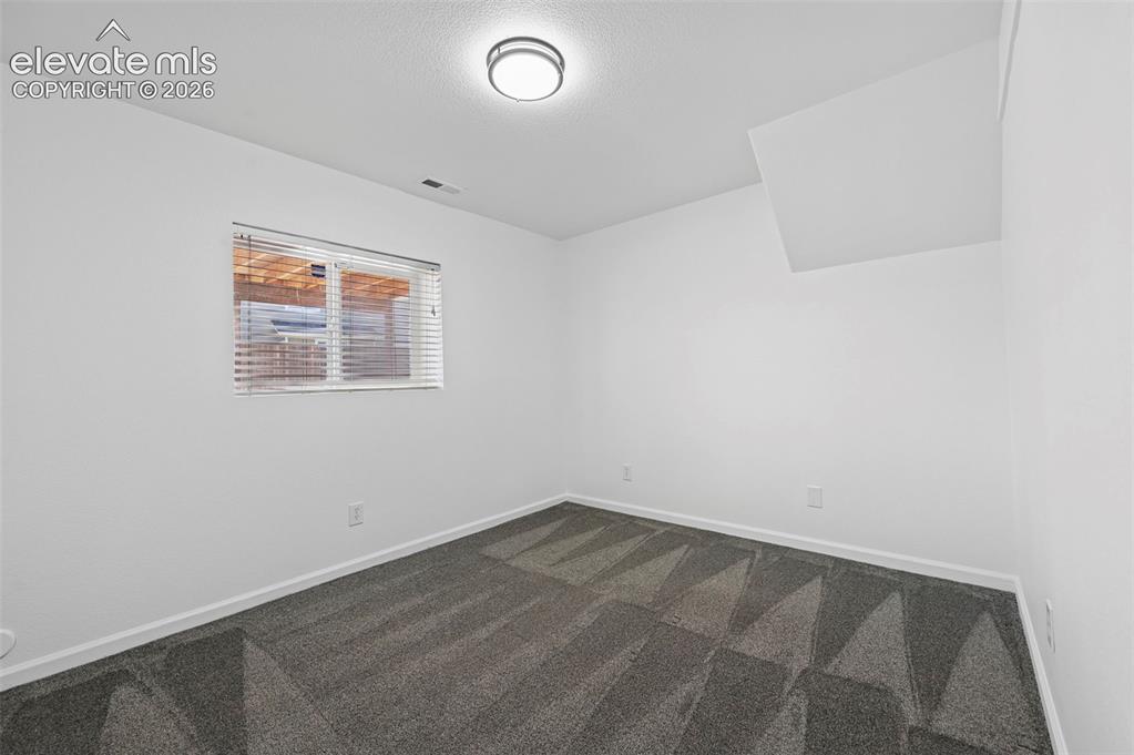 Image 27 of 36: basement bedroom