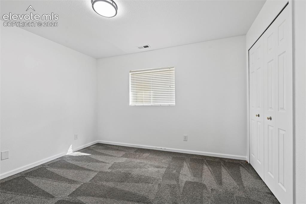 Image 28 of 36: basement bedroom