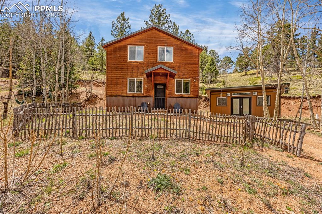 Image 24 of 45: Rustic home featuring an outbuilding