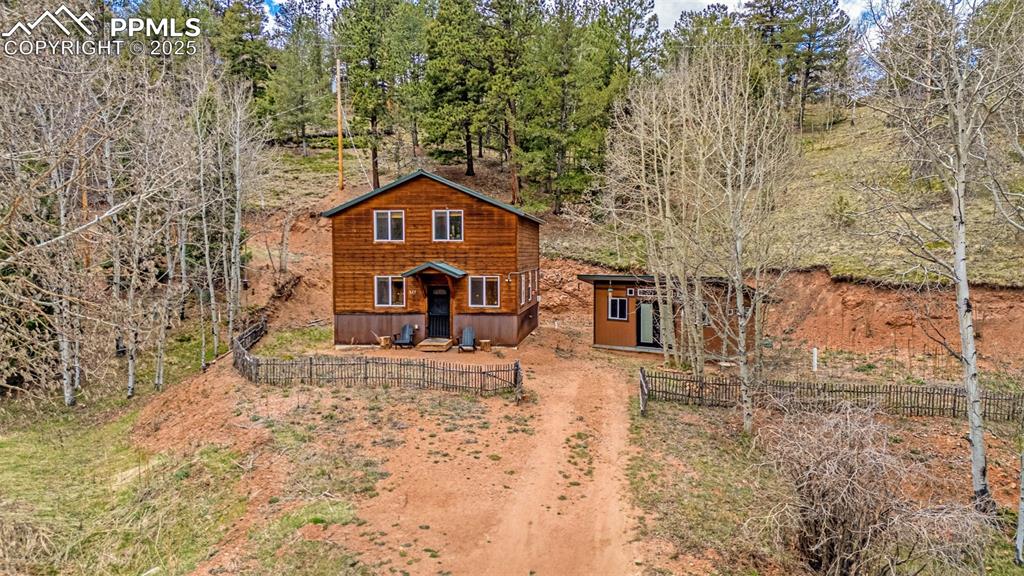 Image 26 of 45: Rustic home featuring fence and an outbuilding