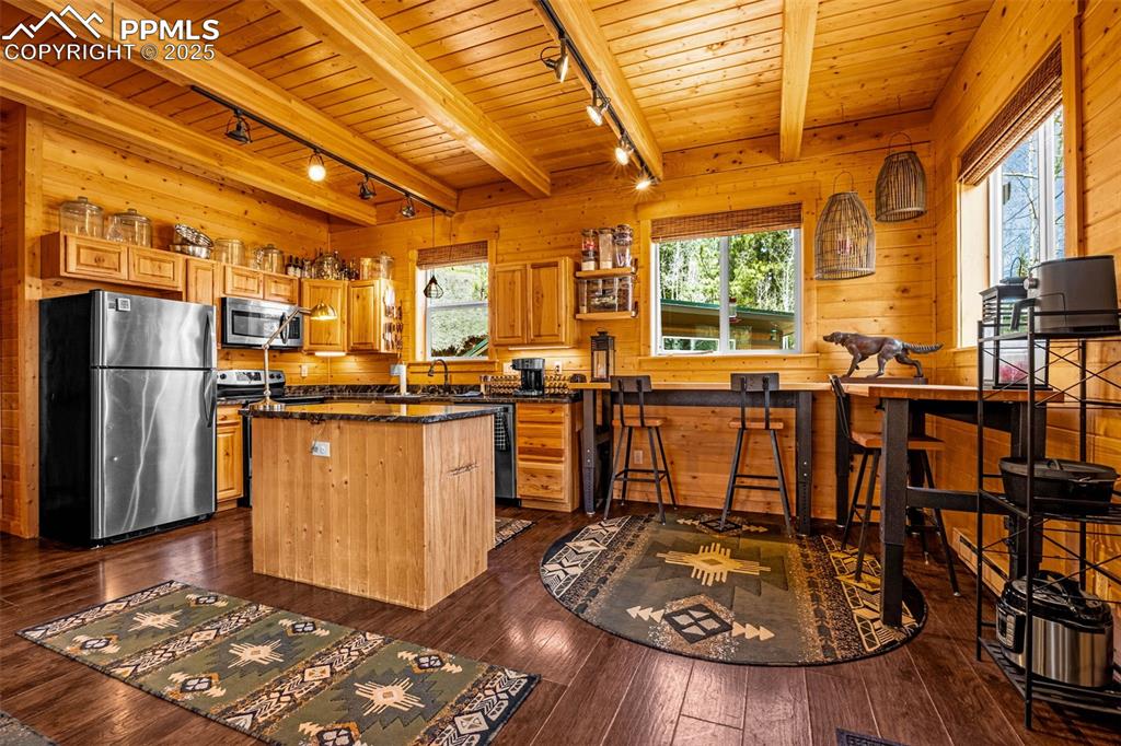 Image 8 of 45: Kitchen featuring track lighting, appliances with stainless steel finishes,