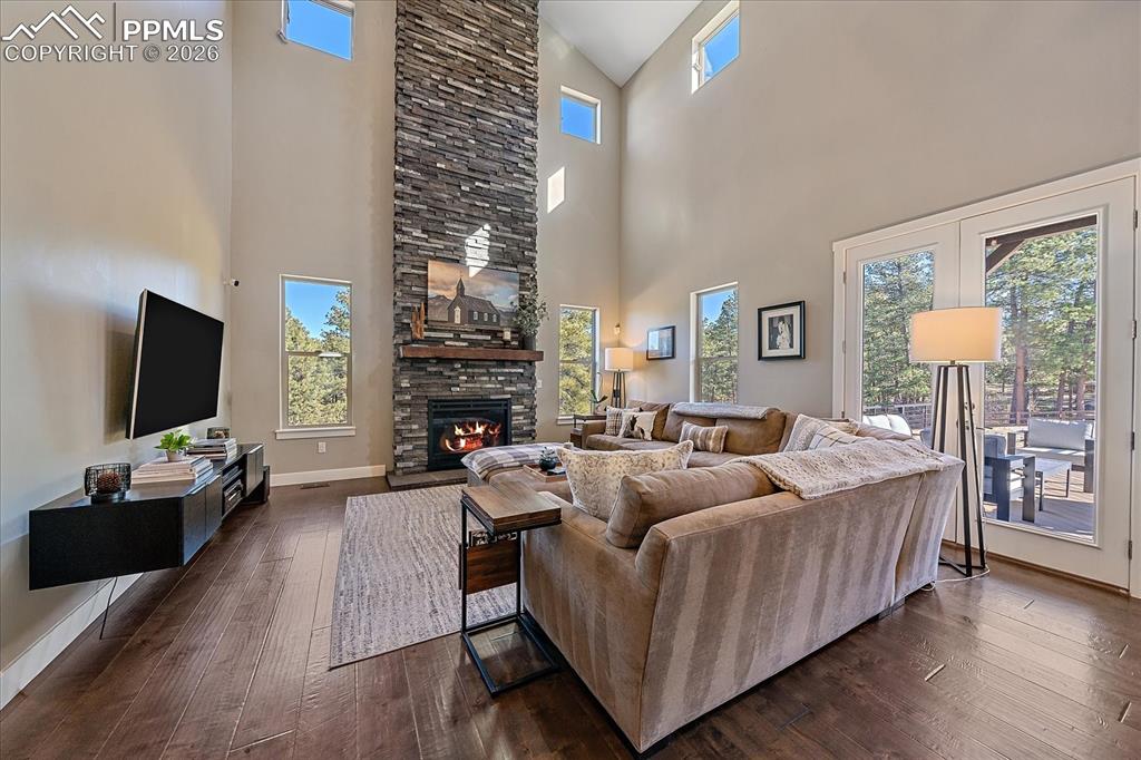 Image 10 of 50: Triple French doors lead guest from the vaulted great room outside