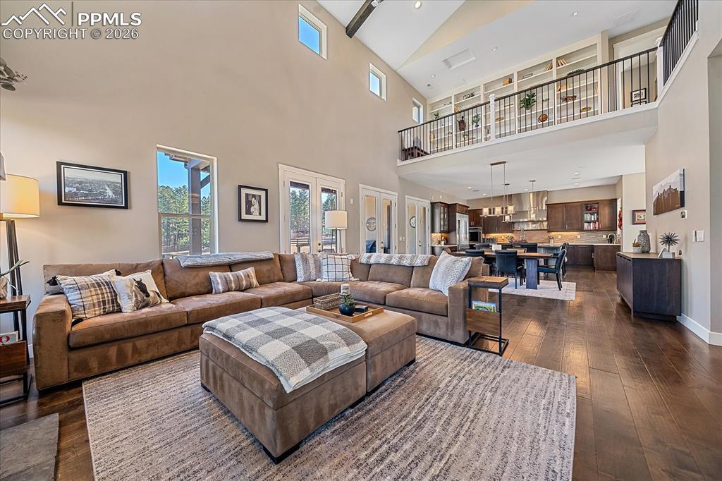 Image 12 of 50: Views from the Great Room into the kitchen area and above a fun library lof