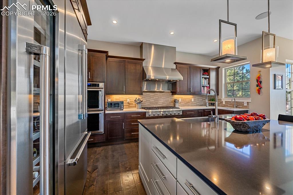 Image 19 of 50: A 54-bottle dual zone wine fridge completes the chef