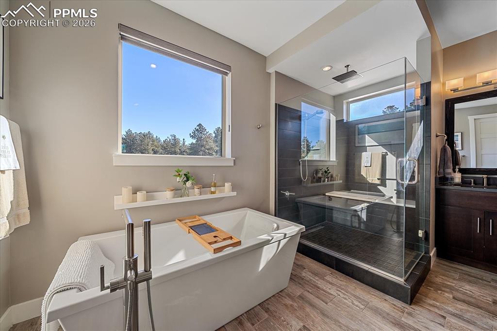 Image 30 of 50: Primary free standing tub and oversized shower 