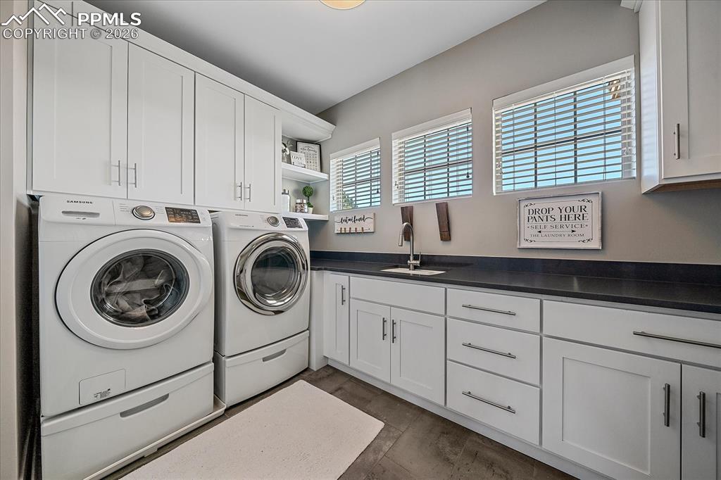 Image 33 of 50: Upstairs laundry with ample storage and folding space - views of the front 