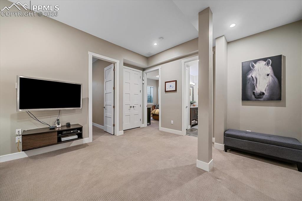 Image 34 of 50: Basement rec/family room area with room to grow into the unfinished space