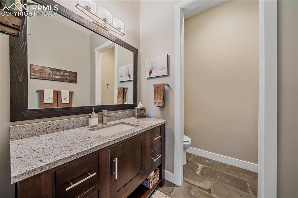 Image 5 of 50: Main floor powder bath with free standing vanity
