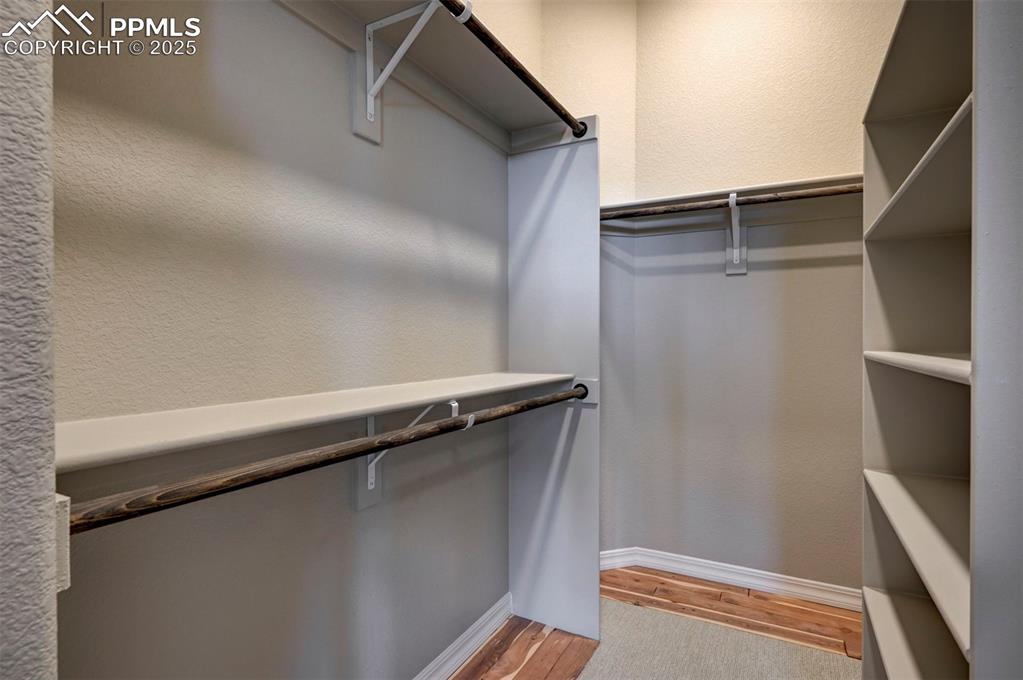Image 21 of 32: Primary suite closet with cedar and solid wood shelving