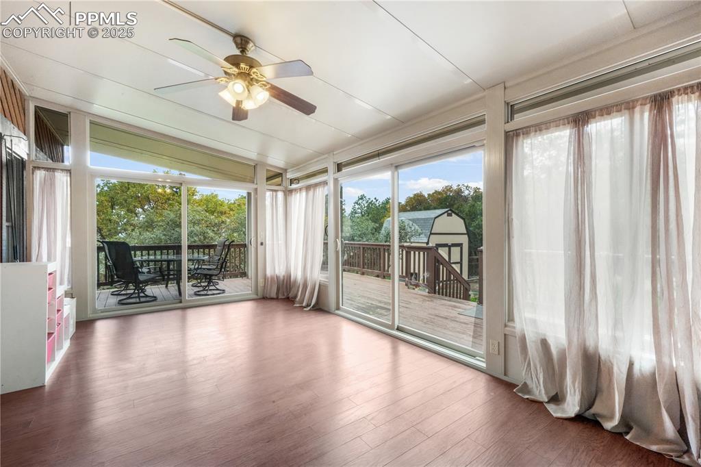 Image 18 of 50: Sunroom access from main living room with additional access to the back dec