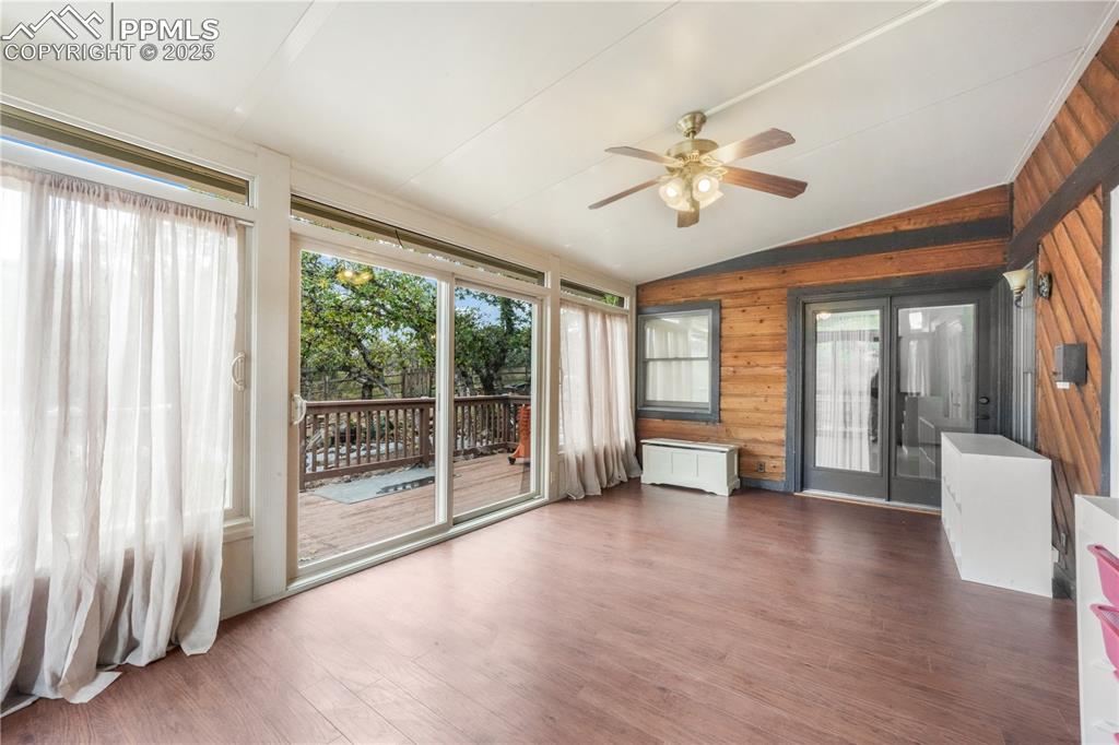 Image 19 of 50: Sunroom access from main living room with additional access to the back dec