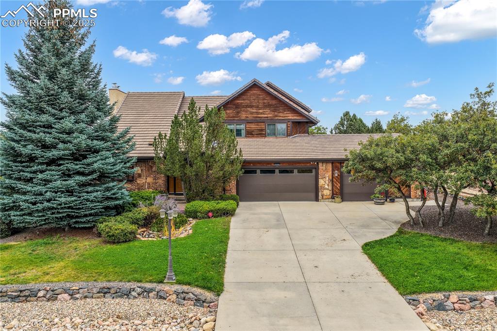 Image 2 of 50: Front of home with mature landscaping
