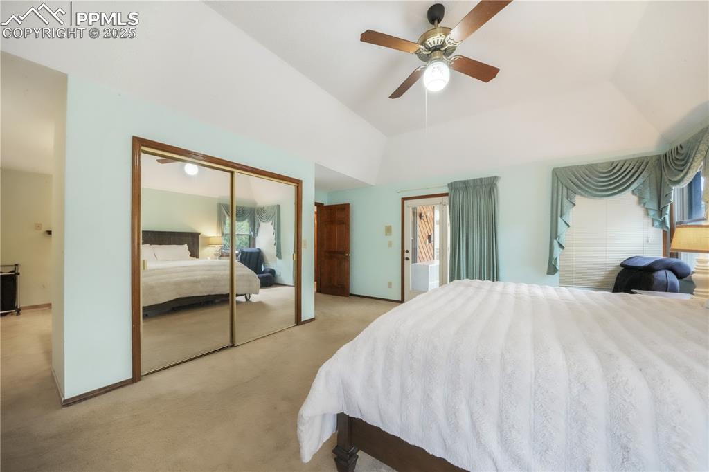 Image 21 of 50: Main level primary bedroom with ensuite bath, large walk in closet and acce