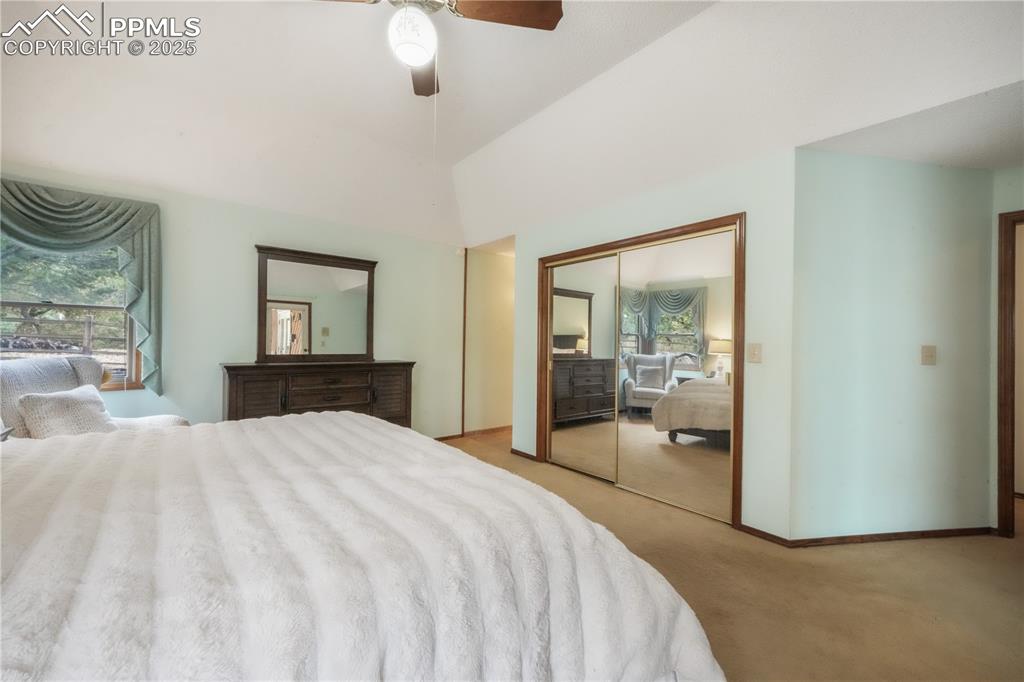 Image 22 of 50: Main level primary bedroom with ensuite bath, large walk in closet and acce