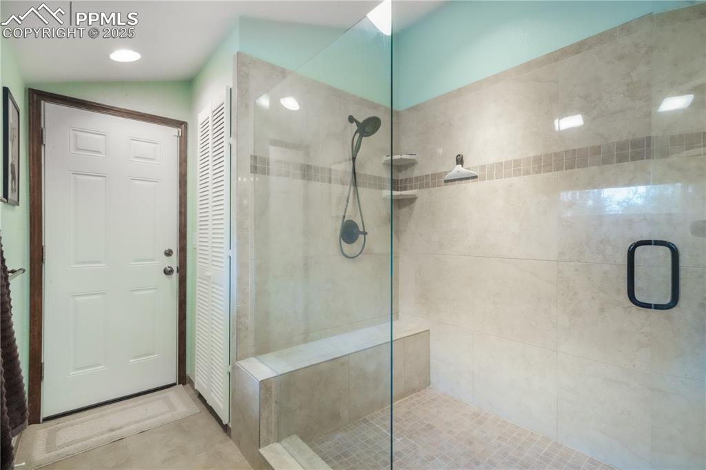 Image 26 of 50: Primary bathroom, dual vanities, expansive walk in shower and access out to