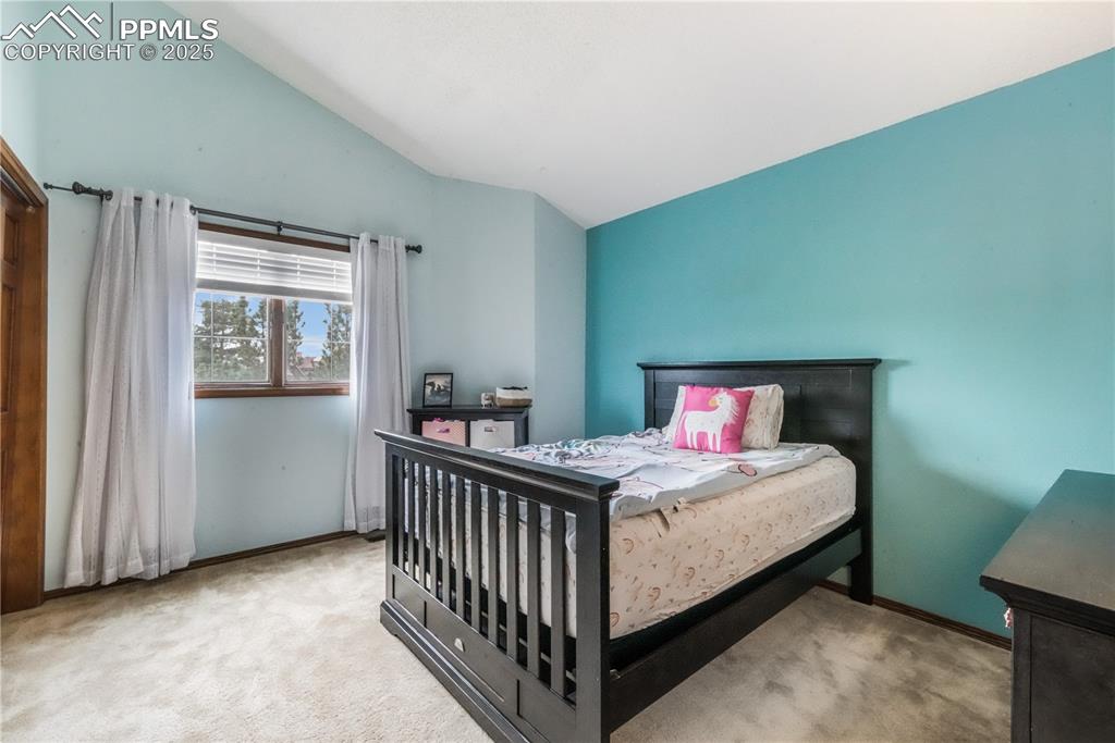 Image 30 of 50: Upper level 2nd bedroom with vaulted ceilings
