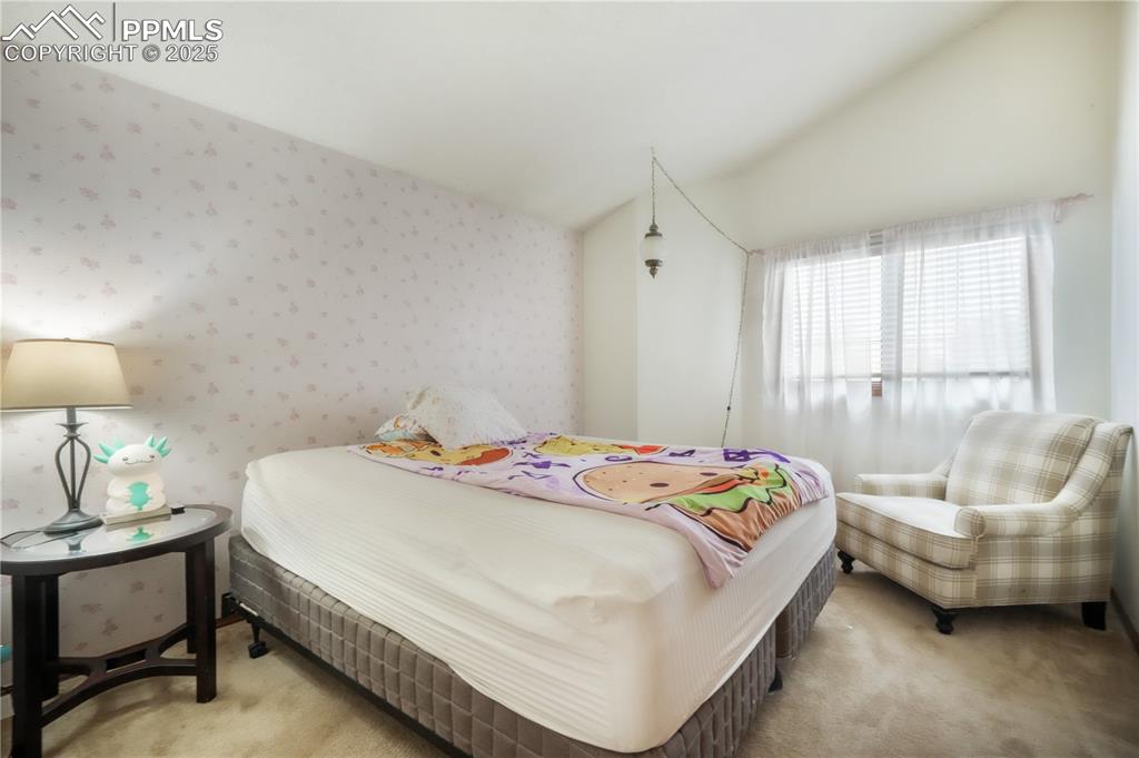 Image 31 of 50: Upper level 3rd bedroom with vaulted ceilings