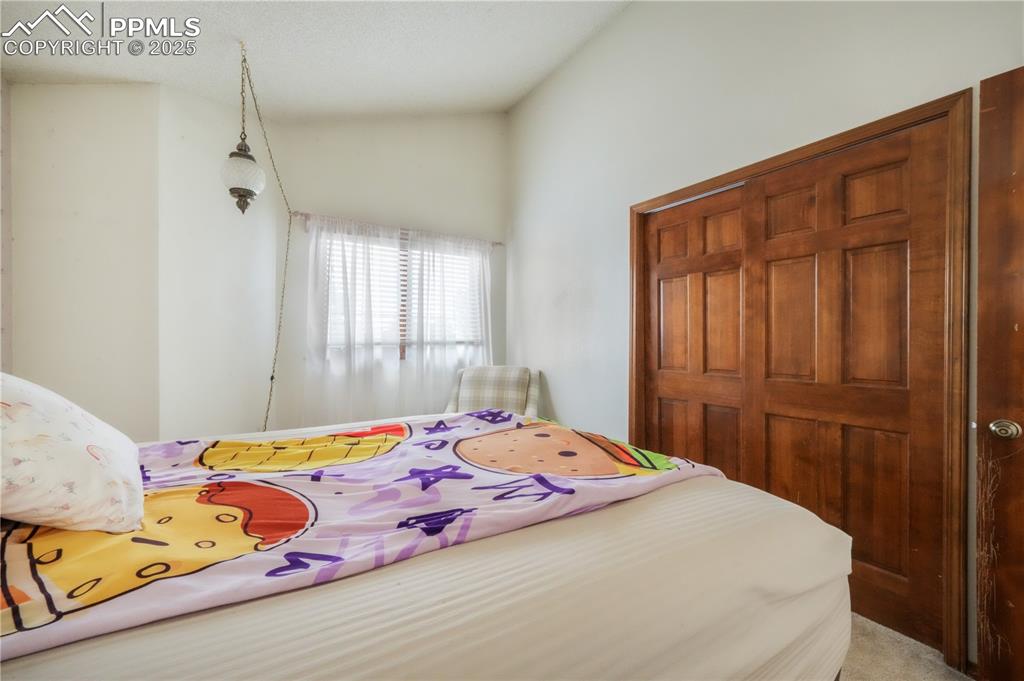Image 32 of 50: Upper level 3rd bedroom with vaulted ceilings
