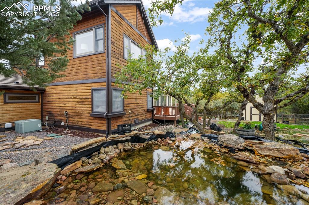 Image 45 of 50: Back yard with large water feature - ready for buyers personal finishes