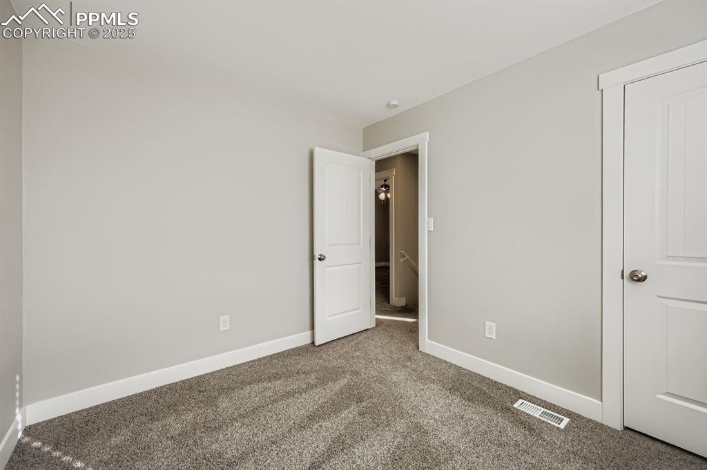 Image 14 of 28: Unfurnished bedroom with carpet floors and baseboards
