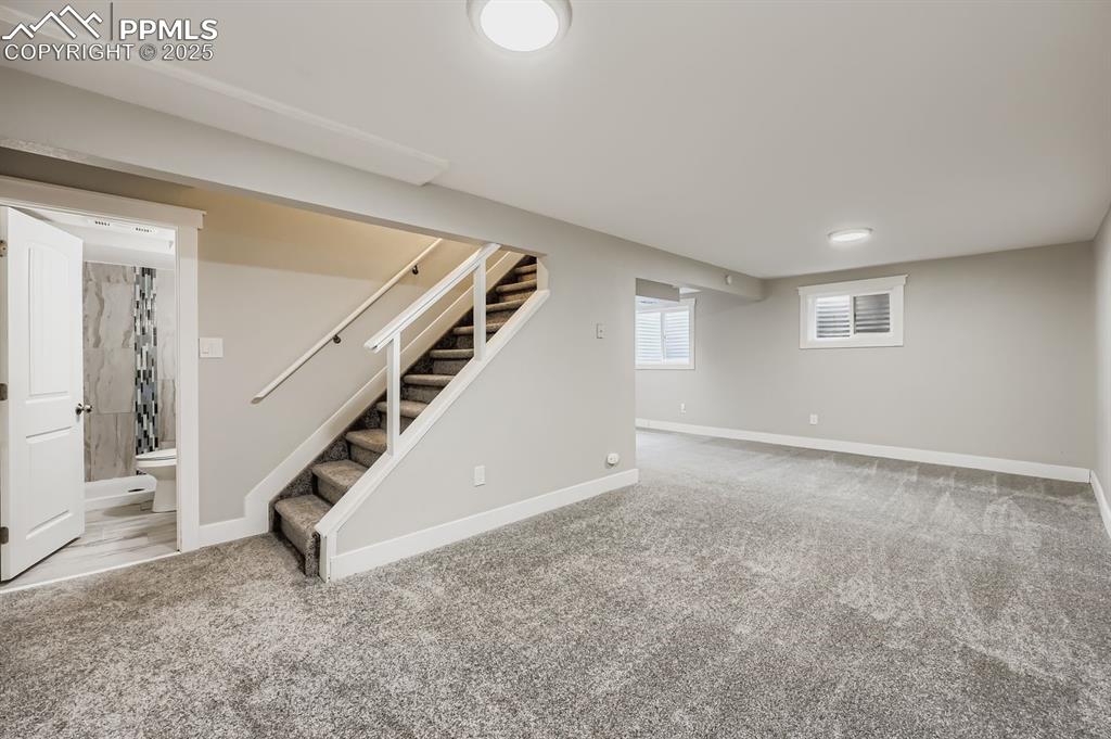 Image 18 of 28: Recreation room with new carpet!
