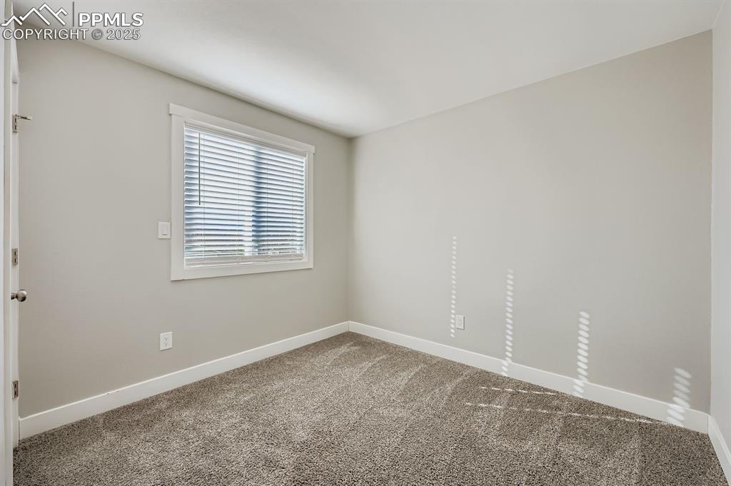 Image 22 of 28: Empty room featuring baseboards and carpet flooring