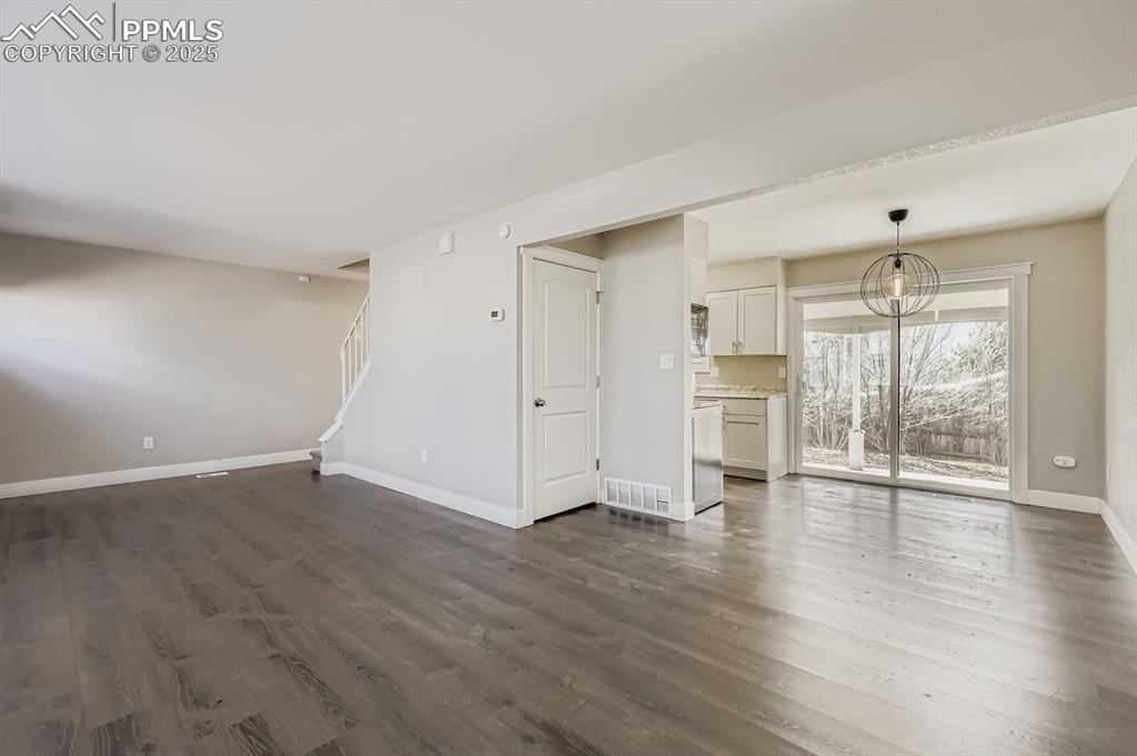 Image 6 of 28: Great space, open bright, luxury flooring...fireplace here and walkout to r