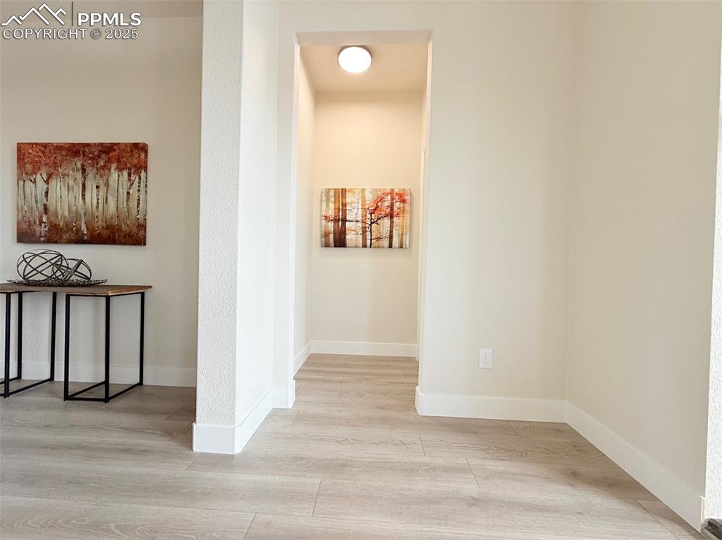 Image 19 of 49: Corridor with light wood finished floors and baseboards