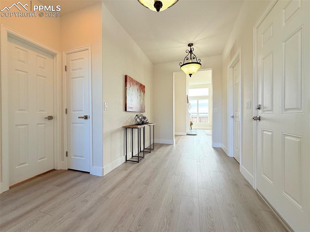 Image 4 of 49: Hallway featuring light wood-style floors and baseboards