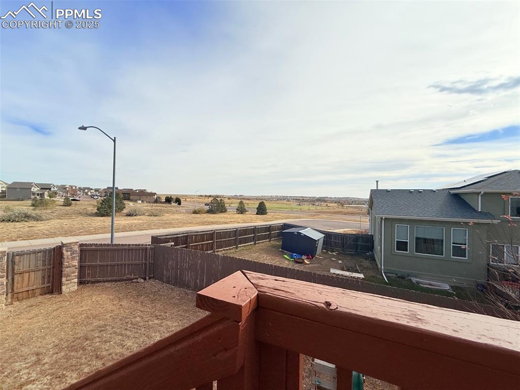 Image 41 of 49: Fenced backyard featuring a rural view and a balcony