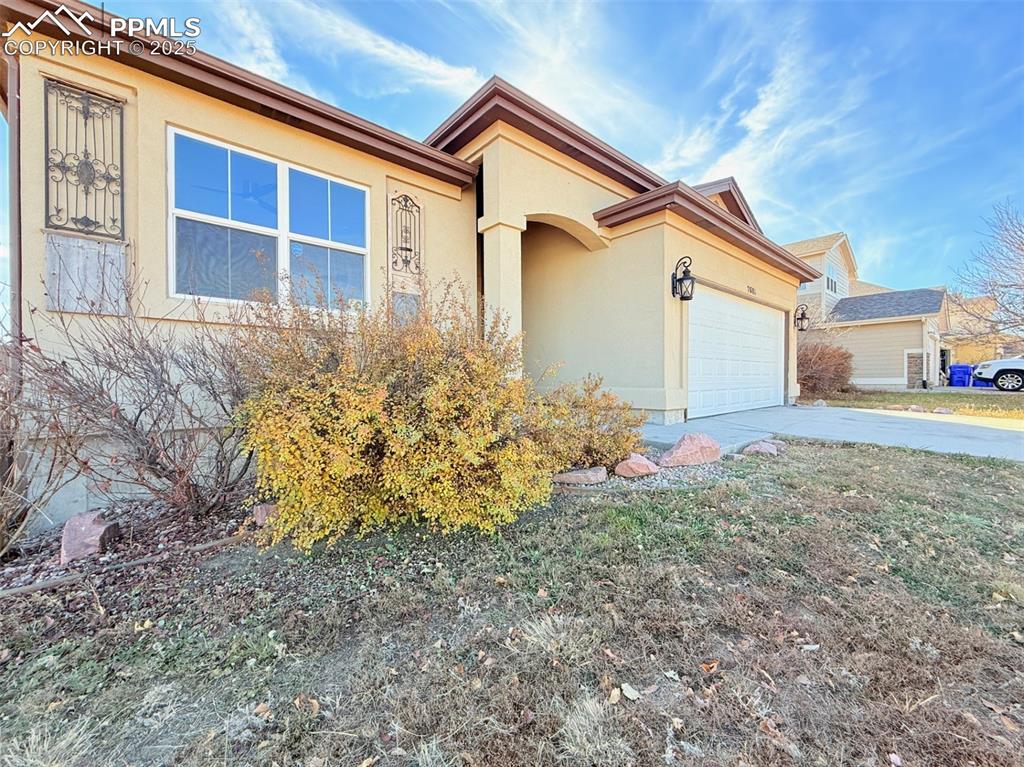 Image 46 of 49: View of front of property with concrete driveway, stucco siding, and an att