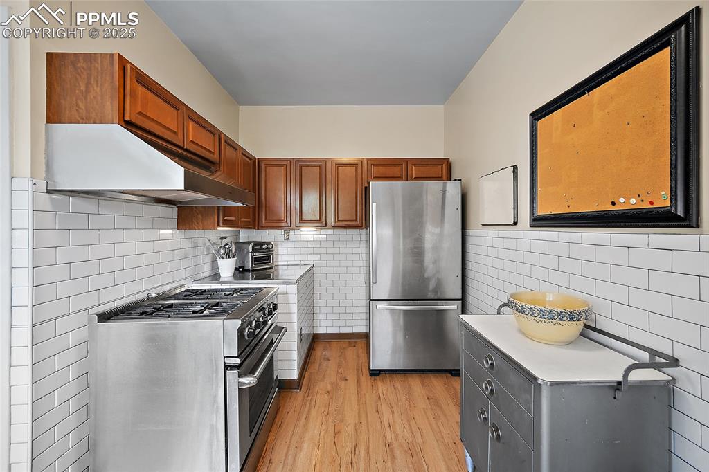 Image 14 of 39: SS appliances and subway tile