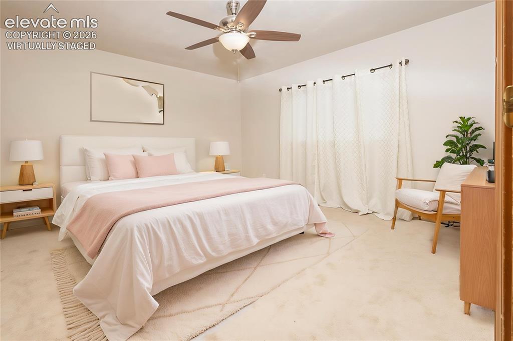 Image 14 of 32: Spacious room featuring a ceiling fan with integrated lighting, broad windo