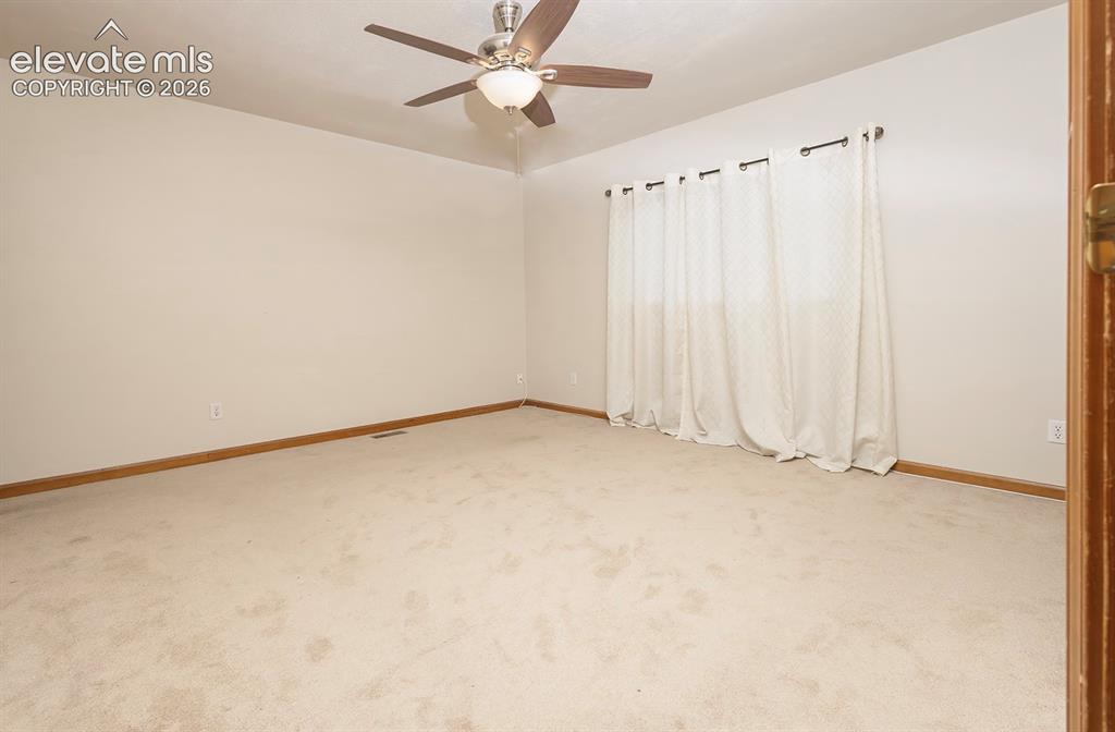Image 29 of 32: Spacious room featuring neutral carpeting and light-toned walls