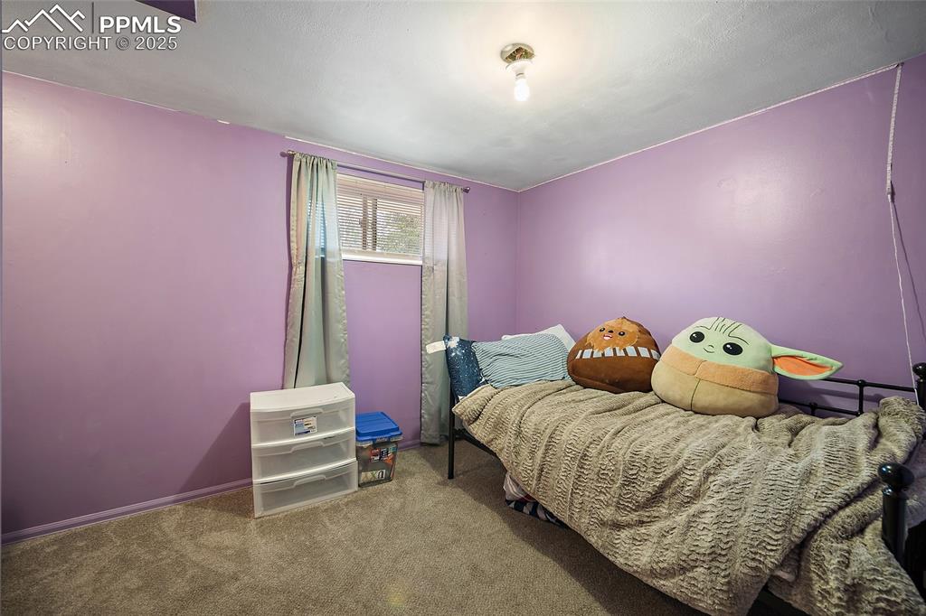 Image 12 of 49: Carpeted bedroom featuring baseboards