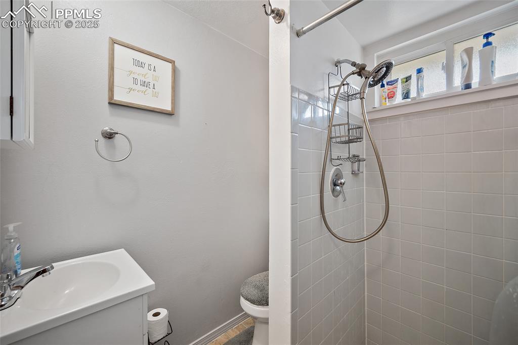 Image 14 of 49: Bathroom with vanity and a stall shower