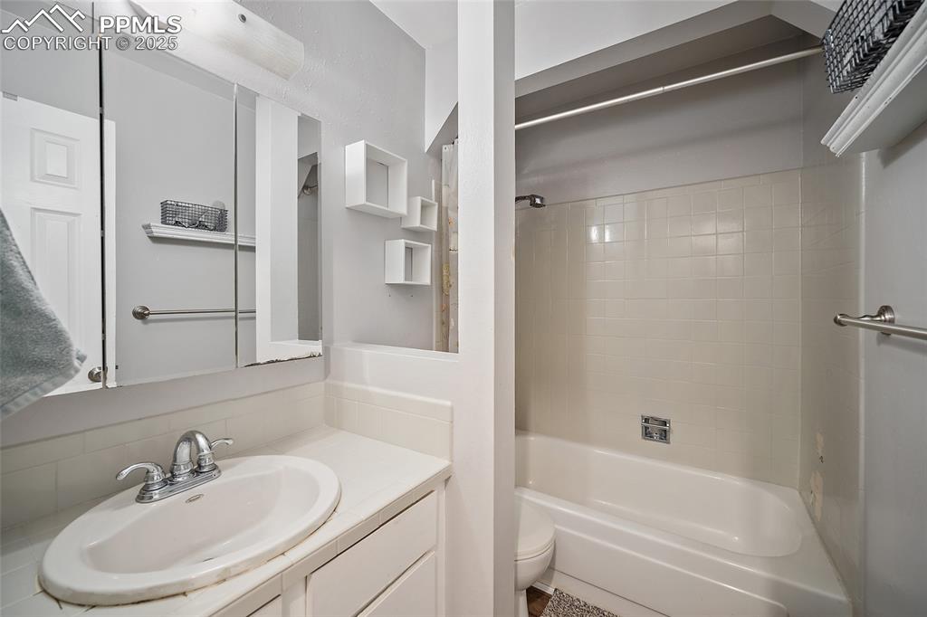 Image 15 of 49: Bathroom with  shower combination and vanity