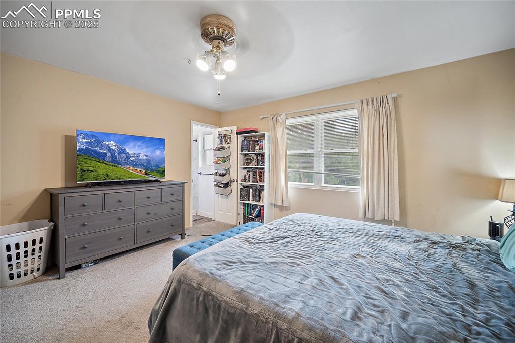 Image 17 of 49: Carpeted bedroom featuring ceiling fan