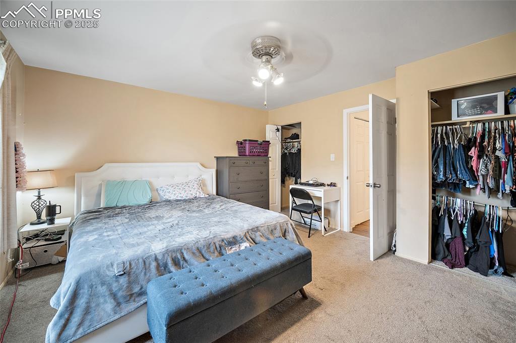 Image 18 of 49: Carpeted bedroom with a closet and ceiling fan