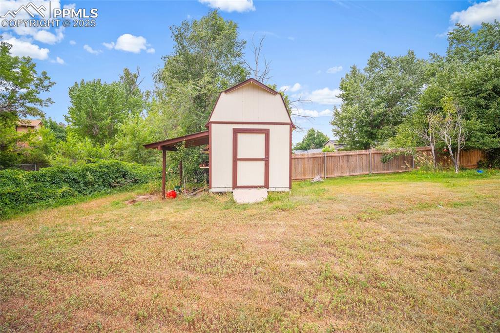 Image 33 of 49: View of yard with a storage unit