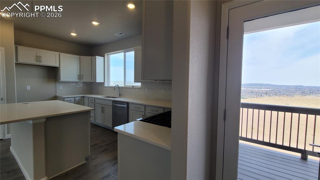 Image 12 of 25: Kitchen with quartz countertops, pantry, large island providing additional 