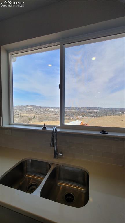 Image 13 of 25: Kitchen with quartz countertops, pantry, large island providing additional 