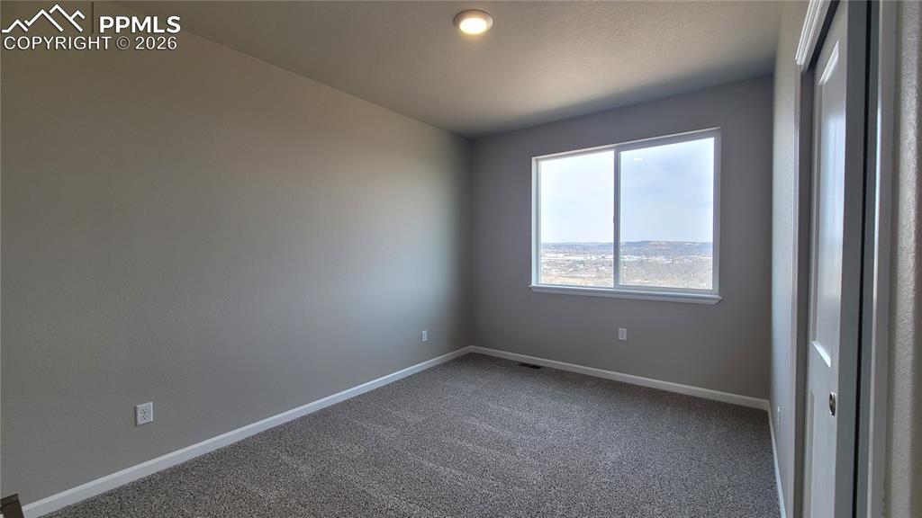 Image 19 of 25: Primary Bathroom with quartz countertop with double vanity, shower, and til