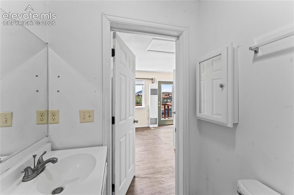 Image 16 of 20: Bathroom vanity featuring an integrated sink with a chrome faucet