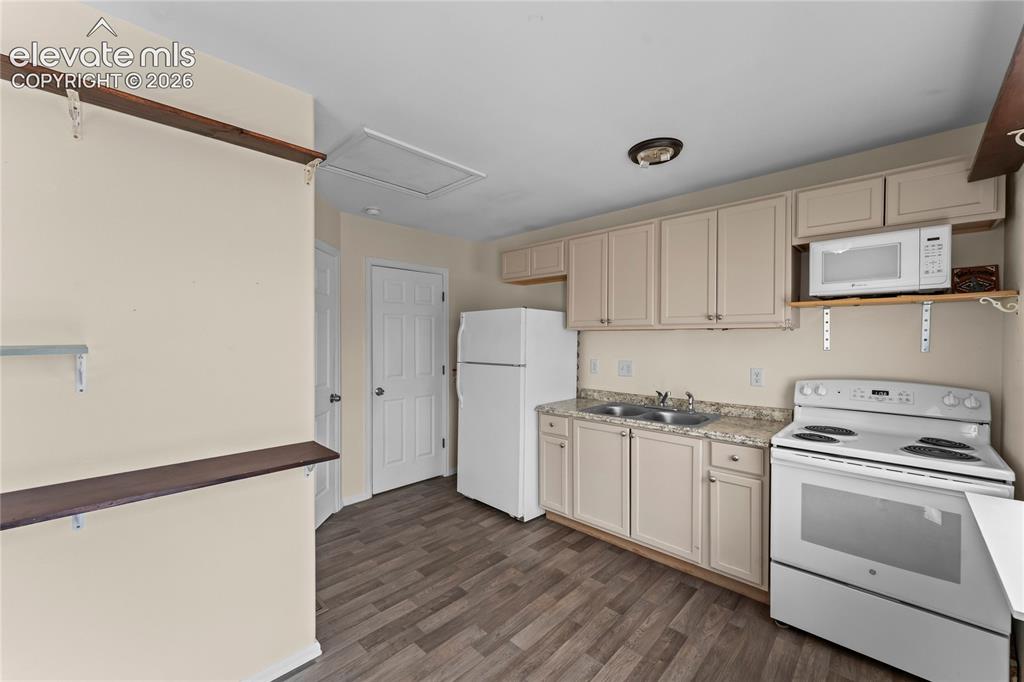Image 4 of 20: Kitchen area featuring wood-finish flooring, light-toned cabinetry, a doubl