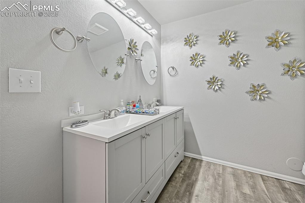 Image 23 of 47: Updated bathroom in the basement with double sinks