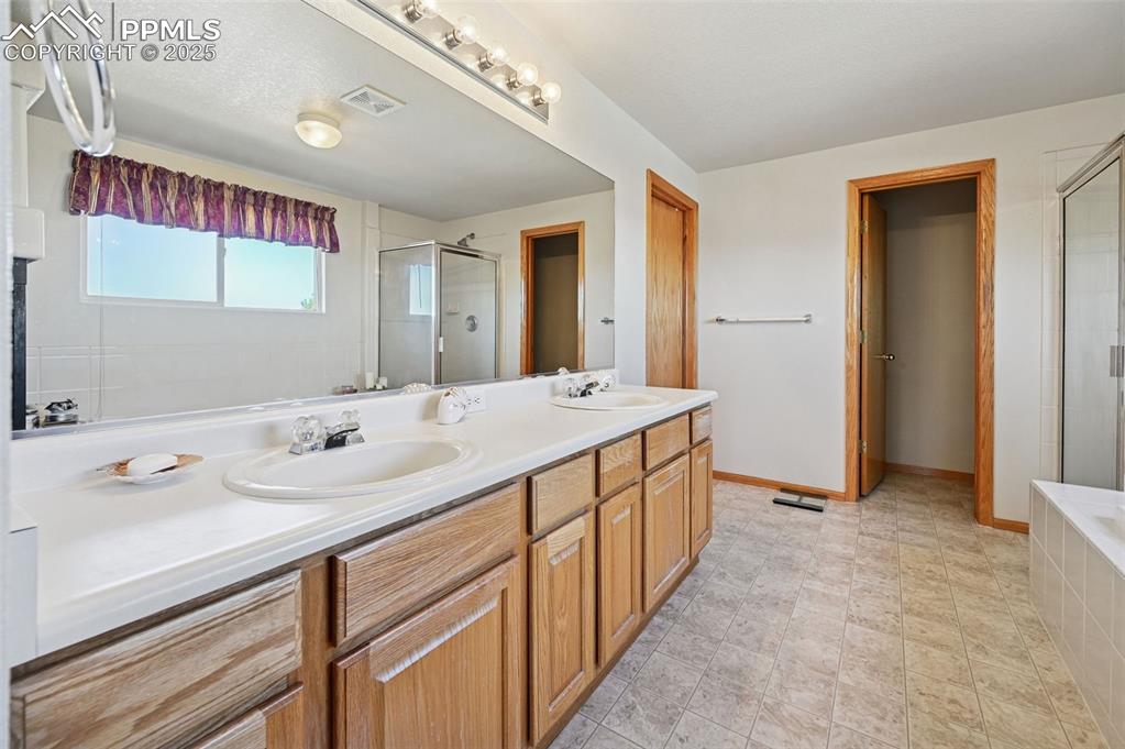 Image 40 of 47: Double sinks in the 5 piece primary  bathroom 