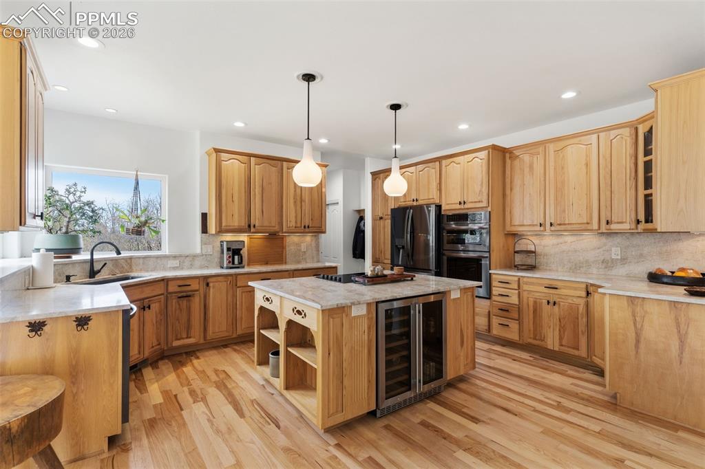 Image 15 of 49: All new black SS appliances with Level 5 Taj Majal quartzite counters & bac